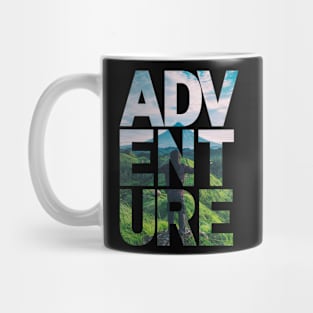 Adventure: Woman overlooking green mountains Mug